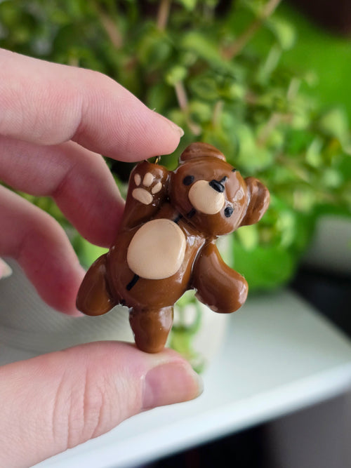 Small brown teddy bear figurine